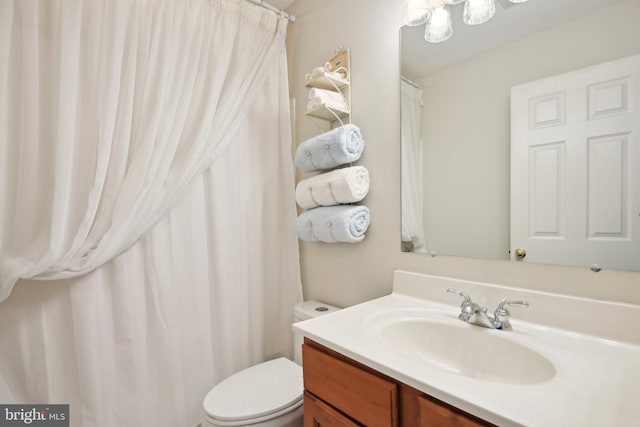 bathroom featuring toilet and vanity