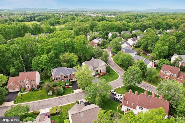 aerial view with a residential view and a view of trees