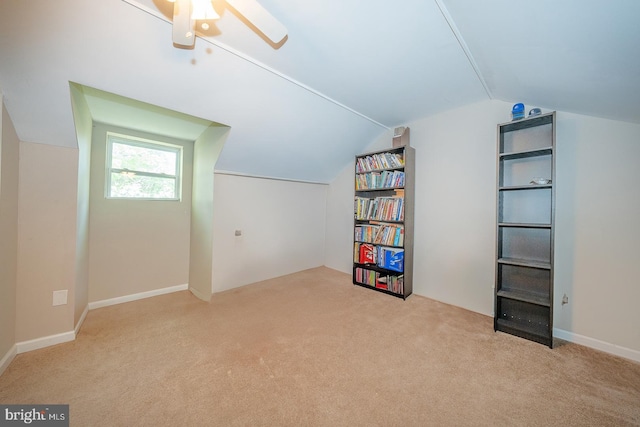additional living space featuring carpet floors, ceiling fan, and lofted ceiling