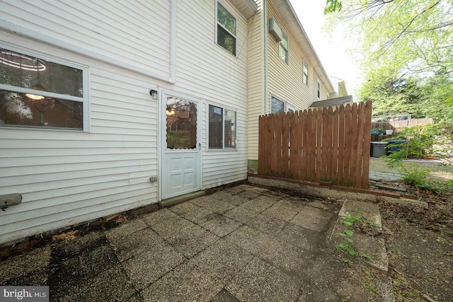 view of property exterior with fence and a patio area