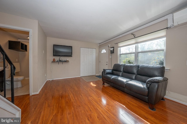 living room featuring baseboards and light wood finished floors
