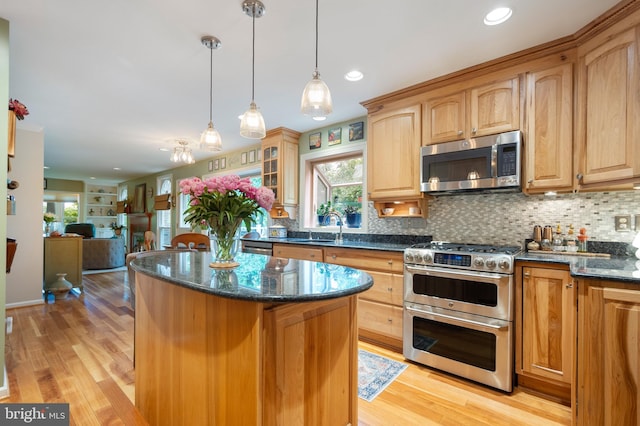 7228 Devereux Ct, Alexandria, VA 22315 - kitchen with appliances with stainless steel finishes, a center island, plenty of natural light, light wood-style flooring, and recessed lighting