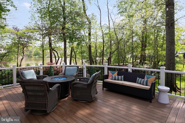 7228 Devereux Ct, Alexandria, VA 22315 - wooden deck featuring an outdoor living space with a fire pit, a water view, and view of wooded area