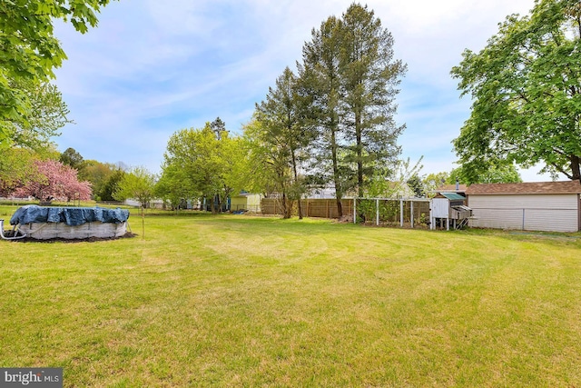 4290 S State St, Camden Wyoming, DE 19934 - view of yard with fence, an outdoor structure, and a covered pool