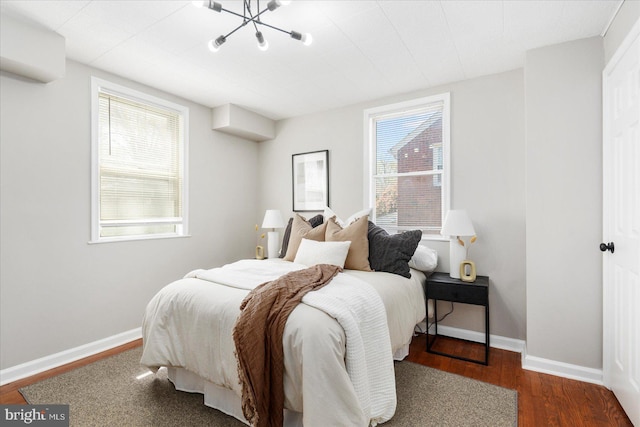 6217 Burgess Ave, Baltimore, MD 21214 - bedroom with a chandelier, wood finished floors, baseboards, and multiple windows