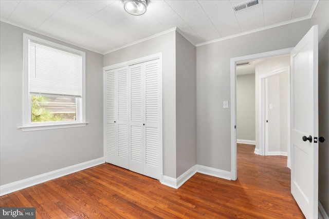 6217 Burgess Ave, Baltimore, MD 21214 - unfurnished bedroom featuring wood finished floors, visible vents, a closet, and ornamental molding