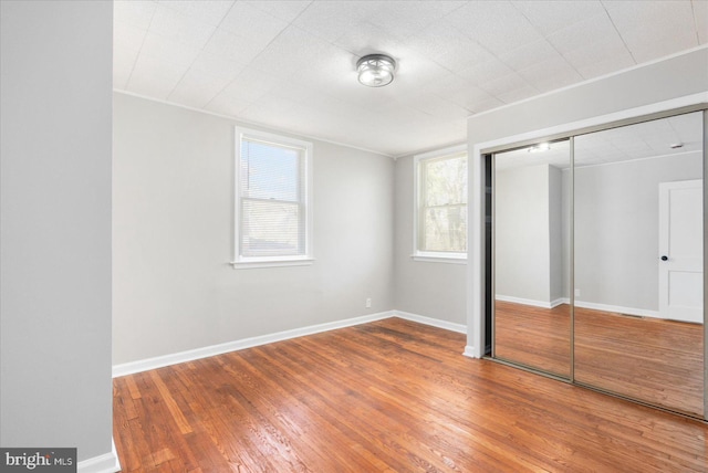 6217 Burgess Ave, Baltimore, MD 21214 - unfurnished bedroom featuring baseboards, wood finished floors, and a closet