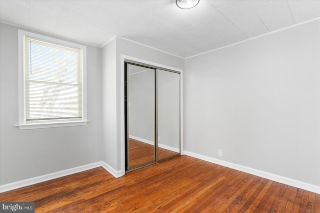 6217 Burgess Ave, Baltimore, MD 21214 - unfurnished bedroom with wood finished floors, a closet, baseboards, and ornamental molding