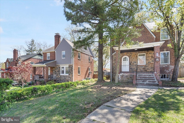 6217 Burgess Ave, Baltimore, MD 21214 - view of front facade with a chimney, a porch, stone siding, and a front yard