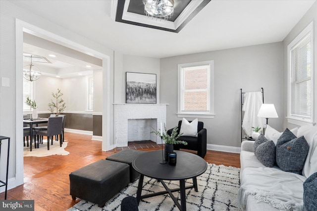 6217 Burgess Ave, Baltimore, MD 21214 - living area featuring wood finished floors, baseboards, a tray ceiling, and a chandelier