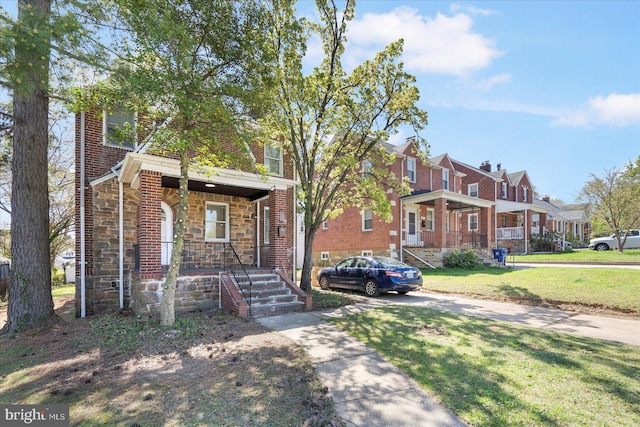6217 Burgess Ave, Baltimore, MD 21214 - view of front of house with stone siding, covered porch, a front yard, brick siding, and a residential view