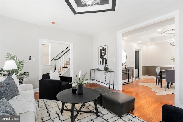 6217 Burgess Ave, Baltimore, MD 21214 - living area featuring a tray ceiling, baseboards, recessed lighting, wood finished floors, and stairs