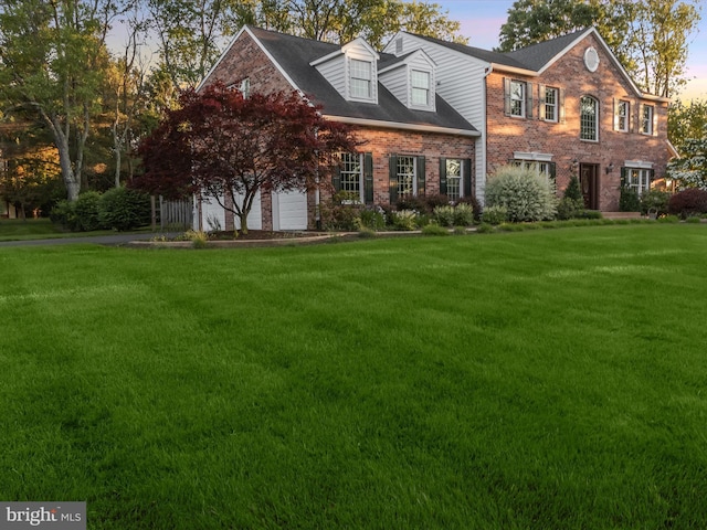 13148 Isle Of Mann Way, Highland, MD 20777 - colonial house with a front lawn, a garage, and brick siding