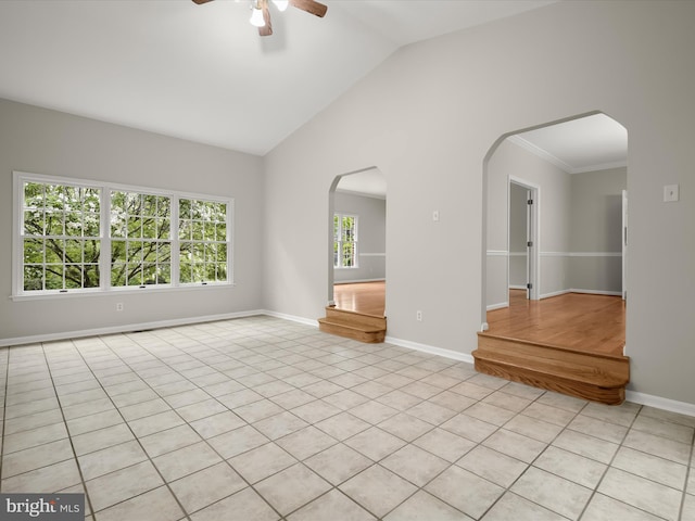 13148 Isle Of Mann Way, Highland, MD 20777 - spare room with arched walkways, ceiling fan, baseboards, lofted ceiling, and light tile patterned floors