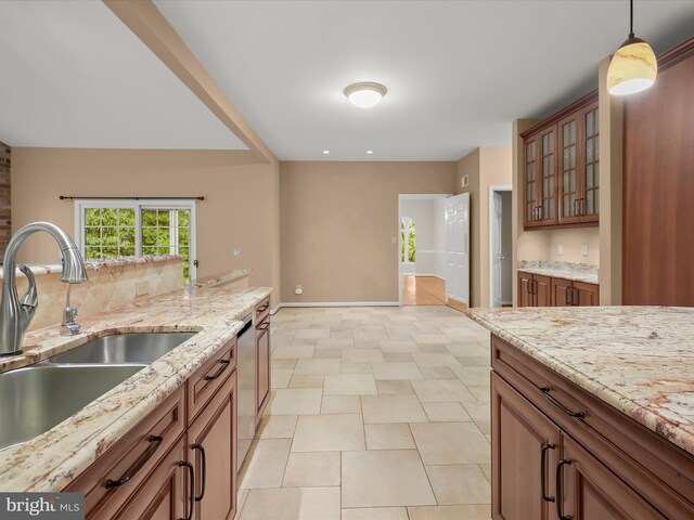 13148 Isle Of Mann Way, Highland, MD 20777 - kitchen with a sink, baseboards, light stone countertops, hanging light fixtures, and glass insert cabinets