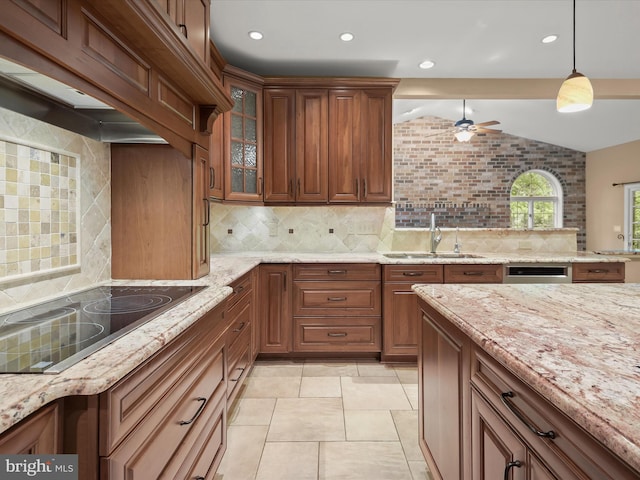 13148 Isle Of Mann Way, Highland, MD 20777 - kitchen with a sink, black electric stovetop, lofted ceiling, decorative backsplash, and light stone counters