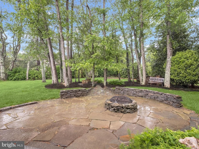 13148 Isle Of Mann Way, Highland, MD 20777 - view of patio / terrace with a fire pit and view of scattered trees