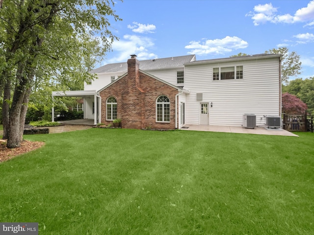 13148 Isle Of Mann Way, Highland, MD 20777 - back of house featuring a patio, cooling unit, a yard, and a chimney