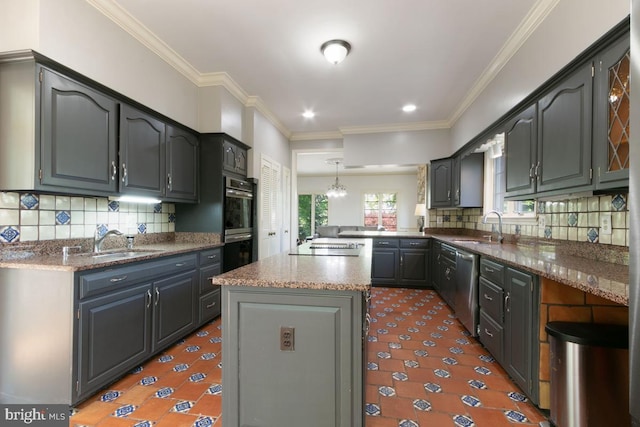 kitchen featuring appliances with stainless steel finishes, a sink, and tasteful backsplash
