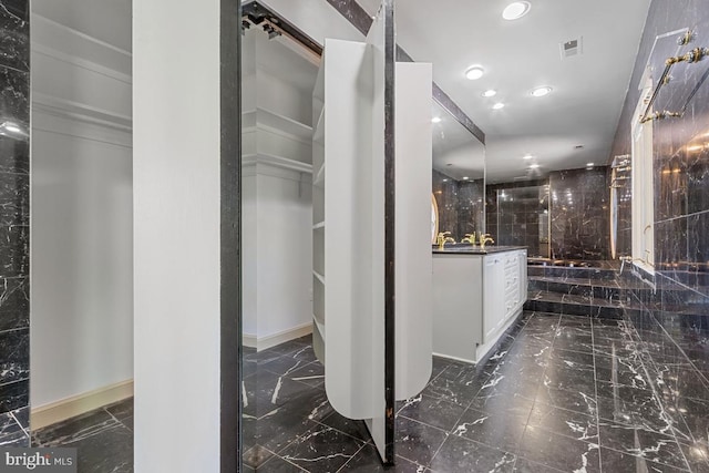 interior space featuring recessed lighting, marble finish floor, baseboards, and visible vents