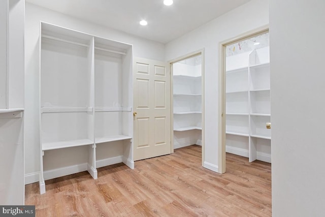 walk in closet featuring light wood-style flooring