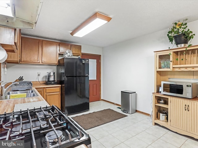 427 Oak Dale Ct, Capon Bridge, WV 26711 - kitchen with black appliances, a sink, light countertops, light tile patterned floors, and open shelves