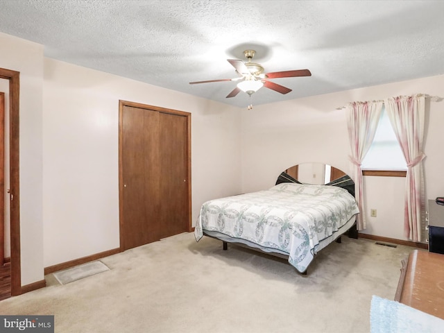 427 Oak Dale Ct, Capon Bridge, WV 26711 - bedroom with a closet, light colored carpet, ceiling fan, baseboards, and a textured ceiling