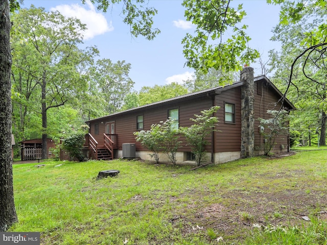 427 Oak Dale Ct, Capon Bridge, WV 26711 - rear view of house with a chimney, a yard, and central AC unit