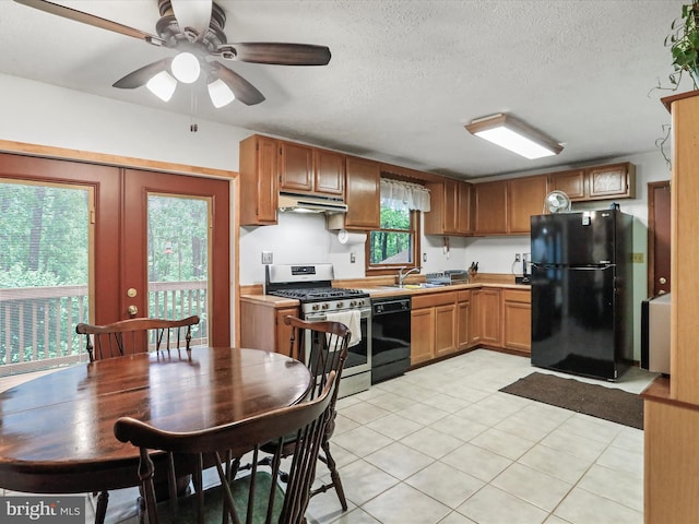 427 Oak Dale Ct, Capon Bridge, WV 26711 - kitchen featuring black appliances, light tile patterned flooring, under cabinet range hood, light countertops, and a textured ceiling