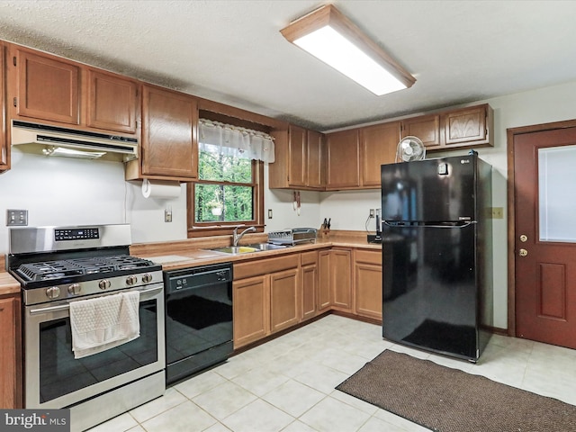 427 Oak Dale Ct, Capon Bridge, WV 26711 - kitchen with black appliances, under cabinet range hood, a sink, light countertops, and light tile patterned floors