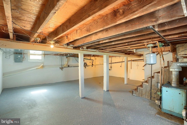 basement with electric panel and stairs