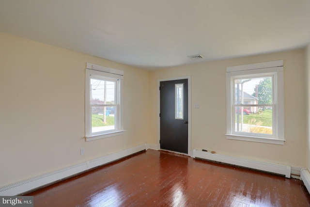 entryway featuring baseboard heating, baseboards, and wood finished floors