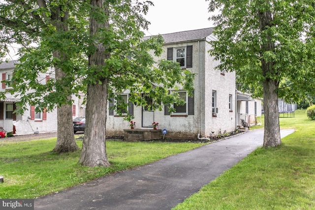 7 Hollywood Ave, Trooper, PA 19403 - view of front of property with a front lawn, driveway, and stucco siding
