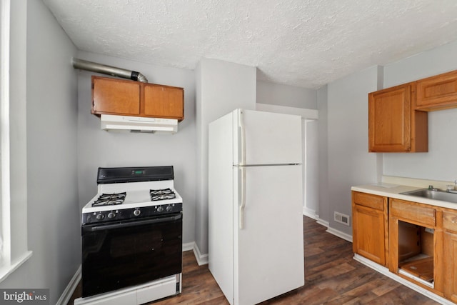 1714 Abbotston St, Baltimore, MD 21218 - kitchen with freestanding refrigerator, range with gas cooktop, under cabinet range hood, dark wood finished floors, and a textured ceiling