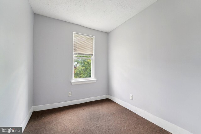 1714 Abbotston St, Baltimore, MD 21218 - unfurnished room with dark carpet, a textured ceiling, and baseboards