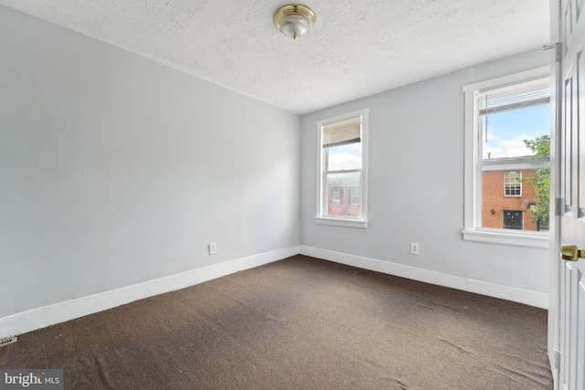 1714 Abbotston St, Baltimore, MD 21218 - unfurnished room featuring dark carpet, a textured ceiling, and baseboards