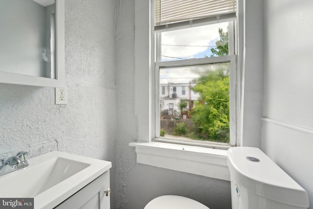 1714 Abbotston St, Baltimore, MD 21218 - bathroom featuring vanity, toilet, and a textured wall