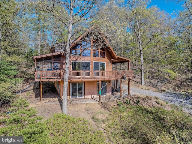 back of property featuring a deck