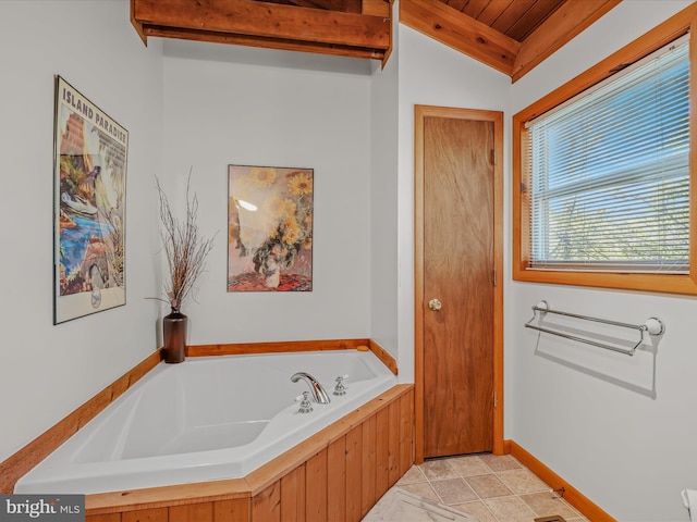 bathroom featuring baseboards, lofted ceiling, wood ceiling, and a garden tub