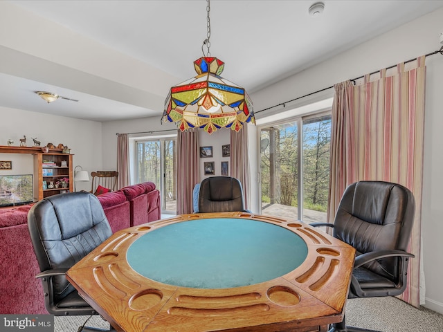 dining space featuring carpet floors and plenty of natural light
