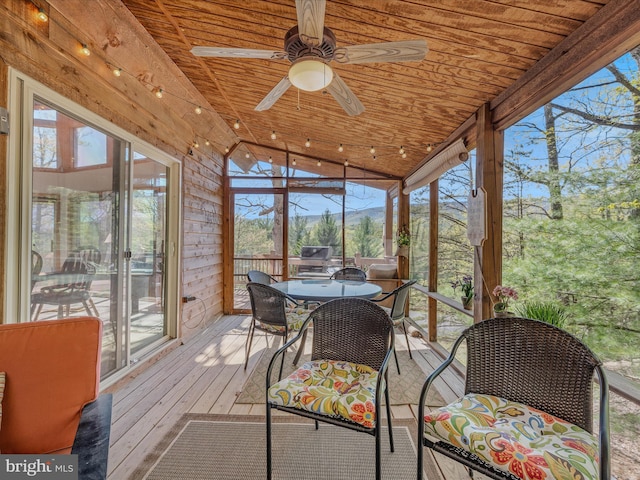 sunroom / solarium with plenty of natural light, outdoor dining area, and ceiling fan