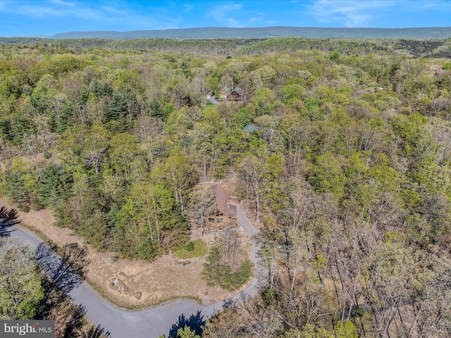birds eye view of property featuring a view of trees