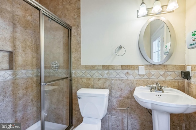 6041 Clairemont Dr, Owings, MD 20736 - bathroom with wainscoting, toilet, tile walls, and a stall shower