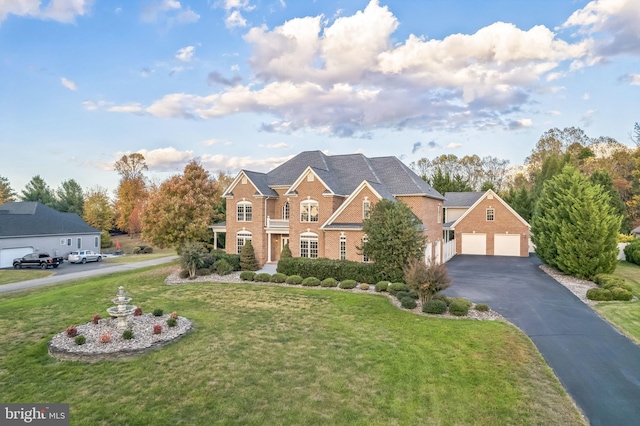 6041 Clairemont Dr, Owings, MD 20736 - view of front of property featuring a garage, brick siding, a front lawn, and aphalt driveway