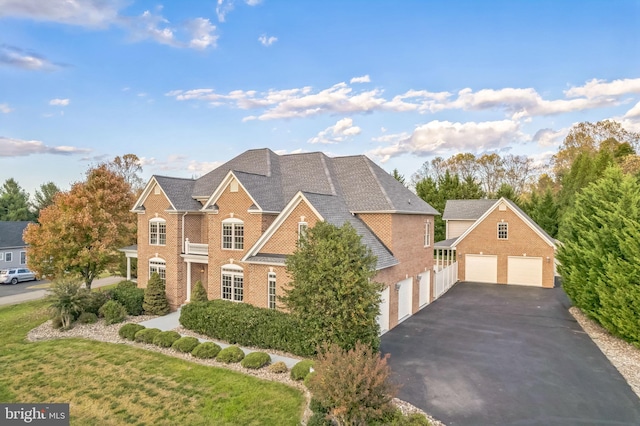 6041 Clairemont Dr, Owings, MD 20736 - traditional-style house with a shingled roof, driveway, brick siding, and a detached garage
