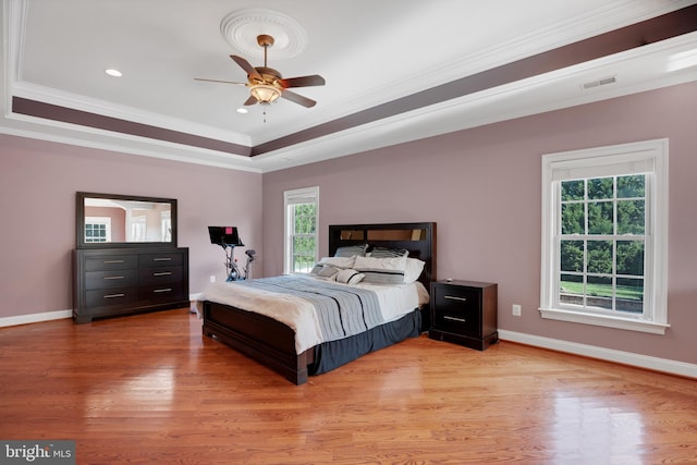 6041 Clairemont Dr, Owings, MD 20736 - bedroom with light wood-style floors, visible vents, crown molding, and multiple windows