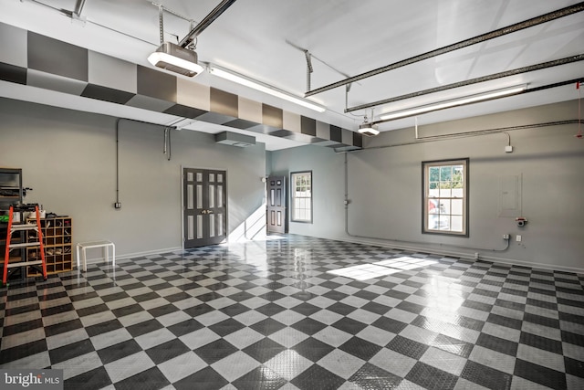 6041 Clairemont Dr, Owings, MD 20736 - garage featuring baseboards and a garage door opener