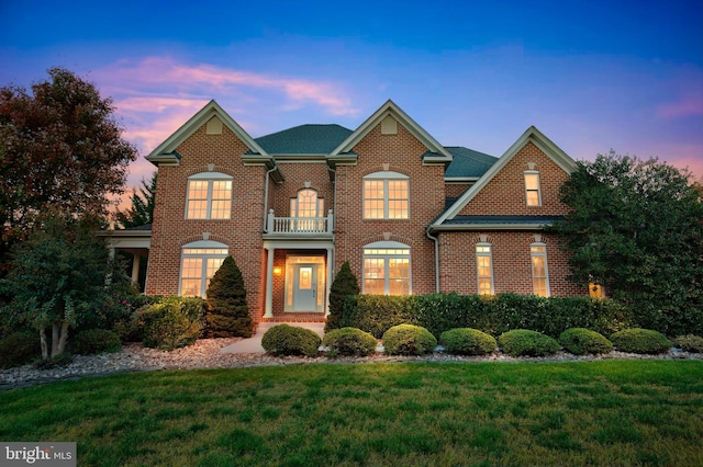 6041 Clairemont Dr, Owings, MD 20736 - view of front of home with a lawn, brick siding, and a balcony