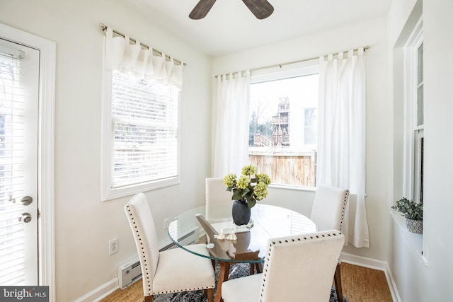dining area featuring baseboards, ceiling fan, and a wealth of natural light