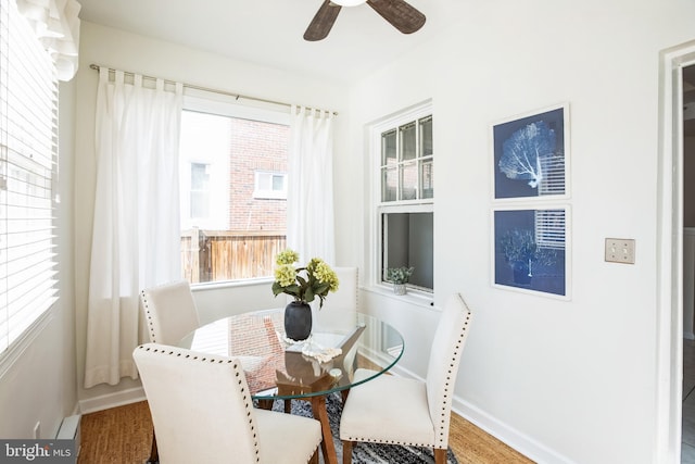 dining area with a ceiling fan and baseboards